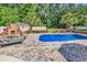 Relaxing pool area with lounge chairs, brick fireplace, and lush greenery, creating a private oasis at 2441 Hunters Trail, Myrtle Beach, SC 29588
