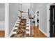 A carpeted staircase with white banisters, leading to the upper level with lots of natural light at 2441 Hunters Trail, Myrtle Beach, SC 29588