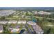 Aerial view of condo community surrounded by lush greenery, mature trees, and a golf course at 260 Woodlands Way # 2, Calabash, NC 28467