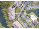 Aerial view of community buildings showcasing lush trees, manicured landscaping, parking, pool, and a pond at 260 Woodlands Way # 2, Calabash, NC 28467