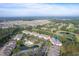 Aerial view of a condo community situated next to a golf course and featuring a community pool at 260 Woodlands Way # 2, Calabash, NC 28467