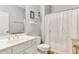 Cozy bathroom with white cabinets, toilet, and a nautical themed shower curtain and décor at 260 Woodlands Way # 2, Calabash, NC 28467