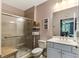 Bathroom featuring a tiled shower, a vanity with storage, and natural lighting at 260 Woodlands Way # 2, Calabash, NC 28467