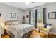 Bedroom featuring a bed with white pillows, hardwood floors, and a bright window at 260 Woodlands Way # 2, Calabash, NC 28467