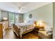 Bedroom featuring hardwood floors, a cozy chair, and a full-sized bed with a floral comforter at 260 Woodlands Way # 2, Calabash, NC 28467