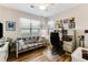 Bright bedroom featuring a futon, desk, and a ceiling fan, providing a comfortable and functional space at 260 Woodlands Way # 2, Calabash, NC 28467