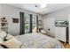 Bedroom featuring a bed with white pillows, hardwood floors, a bright window, and a TV at 260 Woodlands Way # 2, Calabash, NC 28467