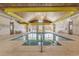 Indoor pool area with tile flooring, multiple windows, and a light-colored wood ceiling at 260 Woodlands Way # 2, Calabash, NC 28467