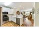 Open concept kitchen with stainless appliances, white cabinets, and laminate flooring at 260 Woodlands Way # 2, Calabash, NC 28467