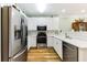 Bright kitchen featuring stainless steel appliances, white cabinets, and modern fixtures at 260 Woodlands Way # 2, Calabash, NC 28467