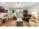 Inviting living room featuring a ceiling fan, hardwood floors, and comfortable seating with a view at 260 Woodlands Way # 2, Calabash, NC 28467