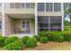 Ground floor porch featuring a seating area and screen, complemented by well-maintained landscaping at 260 Woodlands Way # 2, Calabash, NC 28467