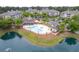 Aerial view of pool and common areas including a clubhouse and pond in a condo community at 260 Woodlands Way # 2, Calabash, NC 28467
