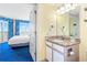 Bathroom with a granite vanity and entry to bedroom with balcony at 2701 S Ocean Blvd. # 902, North Myrtle Beach, SC 29582