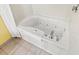 Close-up of a clean white jacuzzi tub with jets and a towel at 2701 S Ocean Blvd. # 902, North Myrtle Beach, SC 29582