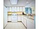 Bright kitchen featuring white cabinetry, granite countertops, and white appliances at 2701 S Ocean Blvd. # 902, North Myrtle Beach, SC 29582