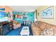 Comfortable living room featuring nautical decor and open layout connecting the kitchen and dining areas at 2701 S Ocean Blvd. # 902, North Myrtle Beach, SC 29582
