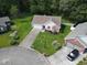 Aerial view of a charming home with manicured lawn, long driveway, and tidy landscaping in a serene setting at 271 Sienna Dr., Little River, SC 29566
