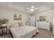Inviting bedroom featuring a patterned bedspread, ceiling fan, and a view of the outdoor landscape at 271 Sienna Dr., Little River, SC 29566