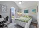Bright bedroom with a vaulted ceiling, large window, and stylish decor provides a comfortable retreat at 271 Sienna Dr., Little River, SC 29566