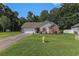 Well-maintained single-story home with a manicured lawn, front yard landscaping, and an attached garage at 271 Sienna Dr., Little River, SC 29566