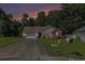 Inviting single-story home with landscaped front yard and driveway, set against a backdrop of mature trees and an evening sky at 271 Sienna Dr., Little River, SC 29566