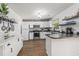 Well-lit kitchen with stainless steel appliances, white cabinets, and granite countertops showcases modern appeal at 271 Sienna Dr., Little River, SC 29566