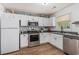 Efficient kitchen featuring white cabinets, stainless steel appliances, and laminate flooring at 271 Sienna Dr., Little River, SC 29566
