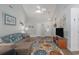 Bright living room with vaulted ceilings, ceiling fan, stylish rug, and modern decor at 271 Sienna Dr., Little River, SC 29566
