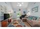 Cozy living room featuring a plush sectional sofa, coastal-themed decor, and sliding door to the backyard at 271 Sienna Dr., Little River, SC 29566