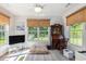 Bright sunroom featuring large windows, a ceiling fan, and neutral decor, ideal for a relaxing space at 271 Sienna Dr., Little River, SC 29566