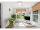 Cozy sunroom filled with natural light, wicker accents, and a view of the backyard offers a serene retreat at 271 Sienna Dr., Little River, SC 29566