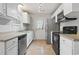 Well-lit kitchen features stainless steel appliances, ample counter space, and white cabinetry at 2712 Austin Ave., Conway, SC 29527