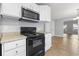Updated kitchen with black appliances, white cabinetry, and easy access to the dining area at 2712 Austin Ave., Conway, SC 29527