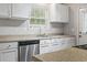 Close up of bright kitchen featuring white cabinets, stainless steel appliances, and window at 2712 Austin Ave., Conway, SC 29527