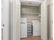 Laundry closet with white washer and dryer and wire shelving at 2712 Austin Ave., Conway, SC 29527