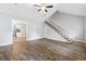 Open-concept living room showcasing wood flooring and staircase access to upper level at 2712 Austin Ave., Conway, SC 29527