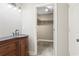 Bathroom vanity leading to carpeted walk-in closet with shelving at 2712 Austin Ave., Conway, SC 29527