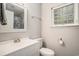 Clean and modern bathroom featuring a vanity sink, toilet, and a decorative privacy window at 2768 Temperance Dr., Myrtle Beach, SC 29577