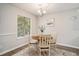 Cozy dining area with a charming chandelier, neutral walls, and a large window offering natural light at 2768 Temperance Dr., Myrtle Beach, SC 29577