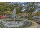 Community fountain surrounded by trees and park benches near Uptown Luxury Living at 2768 Temperance Dr., Myrtle Beach, SC 29577
