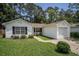 Charming single-story home with a well-manicured lawn, white siding, and attached garage in a lush, green neighborhood at 2768 Temperance Dr., Myrtle Beach, SC 29577