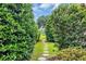 A tranquil backyard stone path is surrounded by manicured shrubbery and landscaping at 290 Dornoch Dr., Pawleys Island, SC 29585