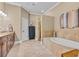 This primary bathroom features a soaking tub, walk-in shower, and custom tiling at 290 Dornoch Dr., Pawleys Island, SC 29585