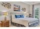 This main bedroom has custom wall art, lamps, a window and ceiling fan at 290 Dornoch Dr., Pawleys Island, SC 29585