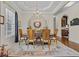 Bright dining room featuring an elegant chandelier, wood floors, and designer touches at 290 Dornoch Dr., Pawleys Island, SC 29585