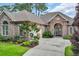 Charming brick home with attached garage, arched entry, and lovely landscaping at 290 Dornoch Dr., Pawleys Island, SC 29585