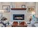 Close up of living room fireplace with stone surround, hearth and custom artwork at 290 Dornoch Dr., Pawleys Island, SC 29585