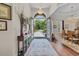 Inviting foyer with chandelier lighting, wood floors, and views to the dining and front yard at 290 Dornoch Dr., Pawleys Island, SC 29585