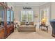 Bright office with a comfortable sofa with throw pillows and a large decorative hutch at 290 Dornoch Dr., Pawleys Island, SC 29585